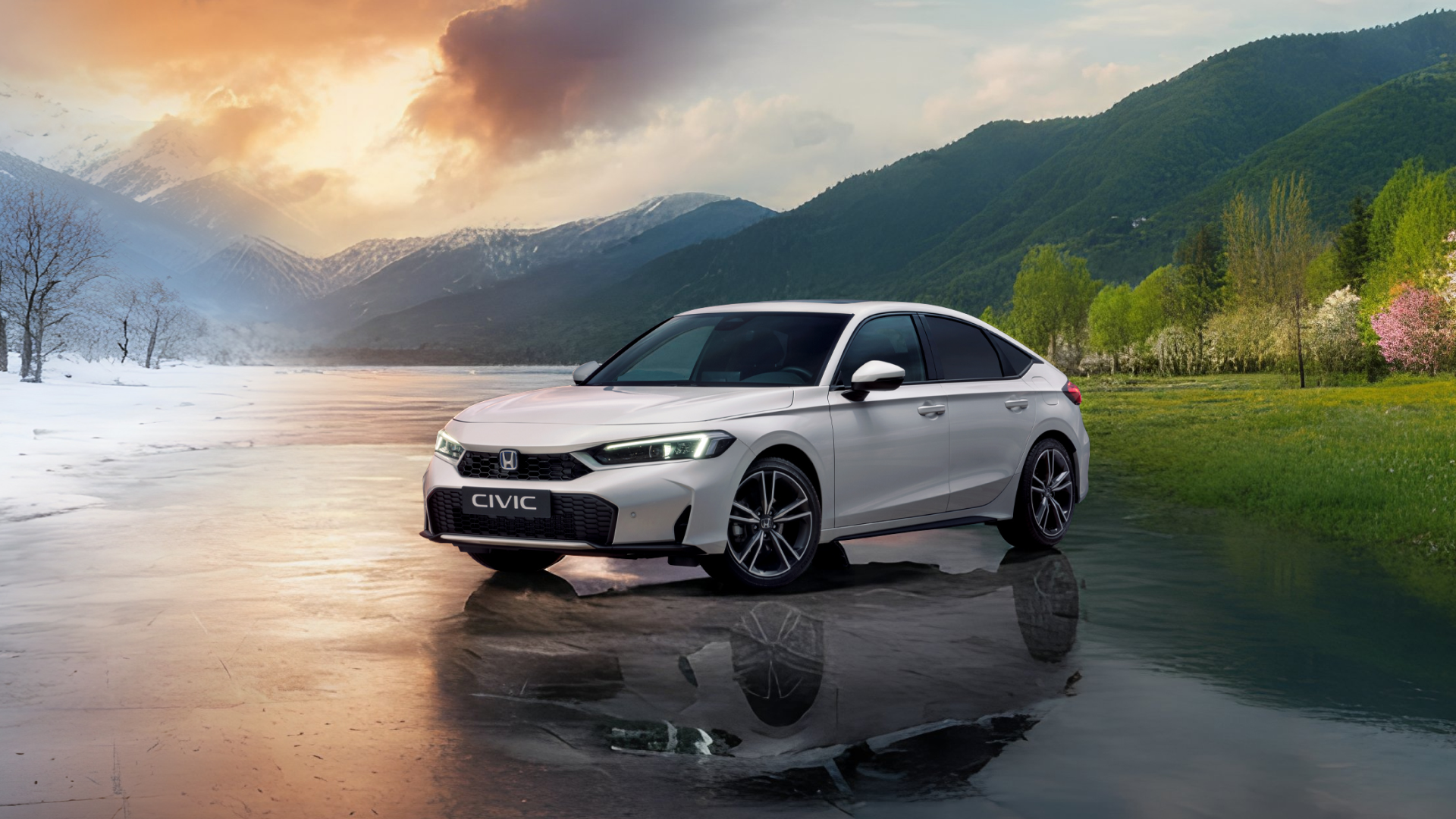 A white Honda Civic sedan parked in a scenic landscape that transitions from snowy mountains to lush green hills. The car is reflected in a smooth water surface, with a dramatic sky featuring warm sunset colors contrasting with the cool tones of the mountains.